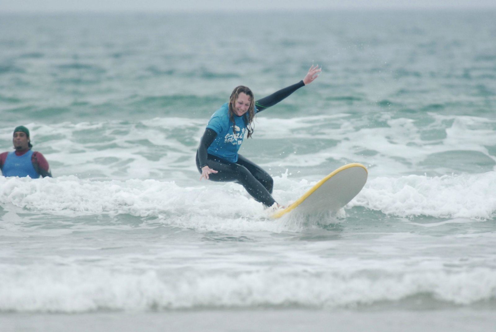 A woman is surfing on the waves in Spain.