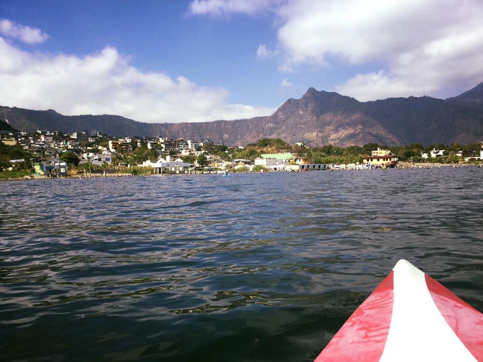 A San Pedro kayak on Lake Atitlan with mountains in the background.