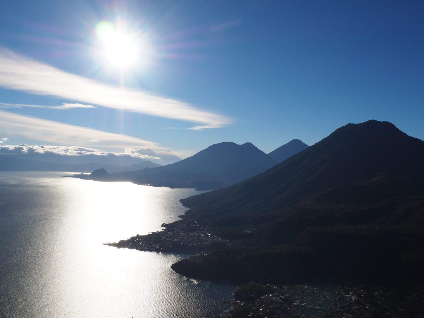 The Indian nose hike offers a breathtaking view of the sun shining over a lake and mountains.