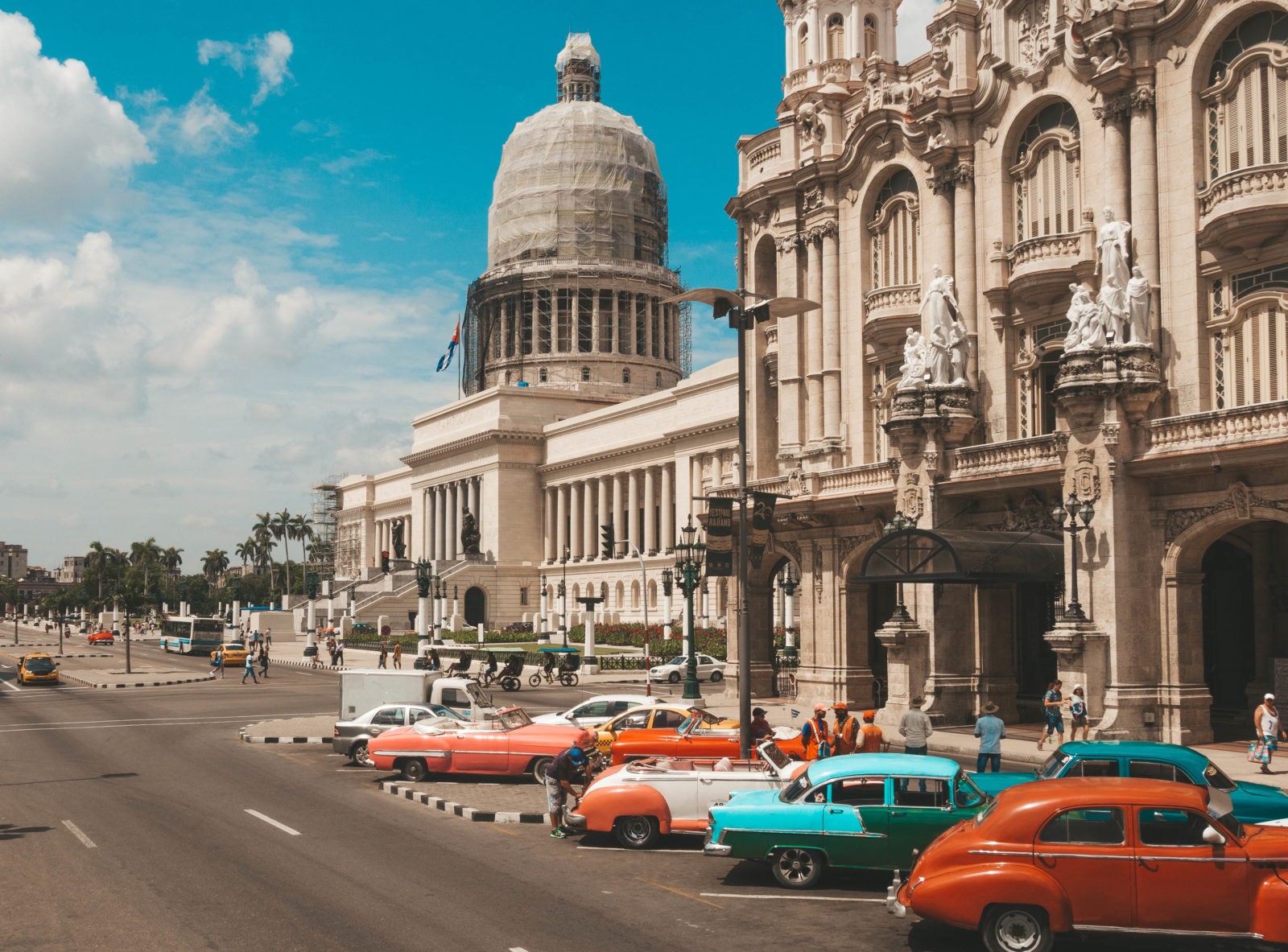 Classic cars parked in front of a building in Havana, capturing the essence of 48 hours in the vibrant city.