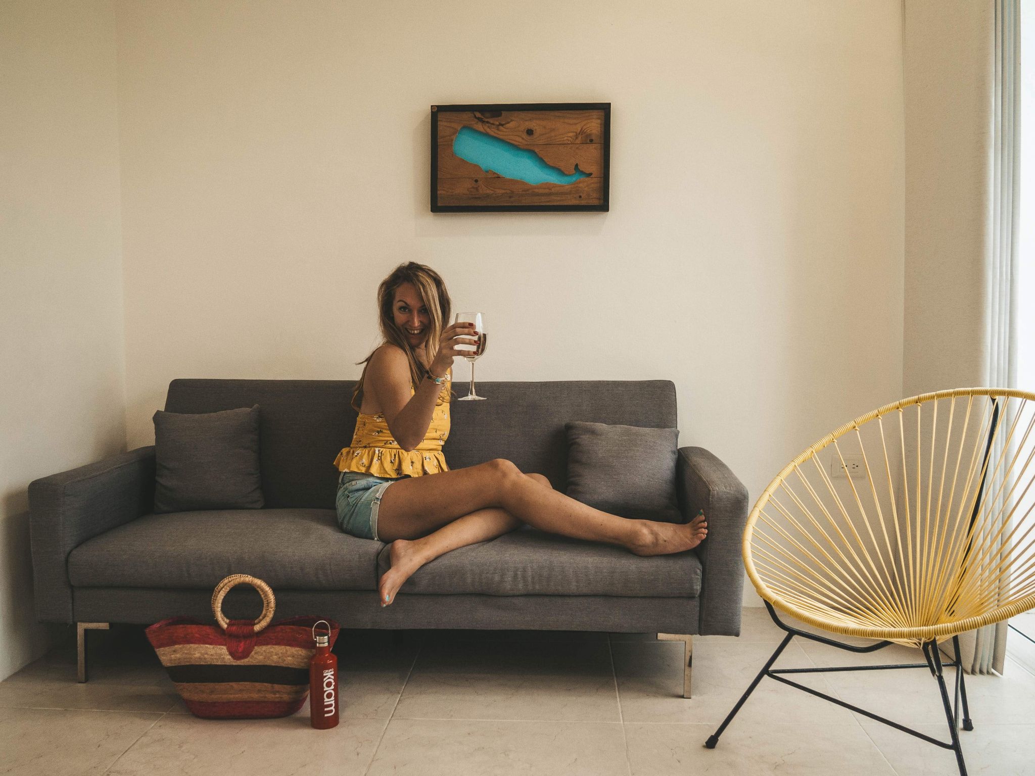 Claire from Claire's Itchy Feet with a glass of wine in Kaam Condos Puerto Morelos.