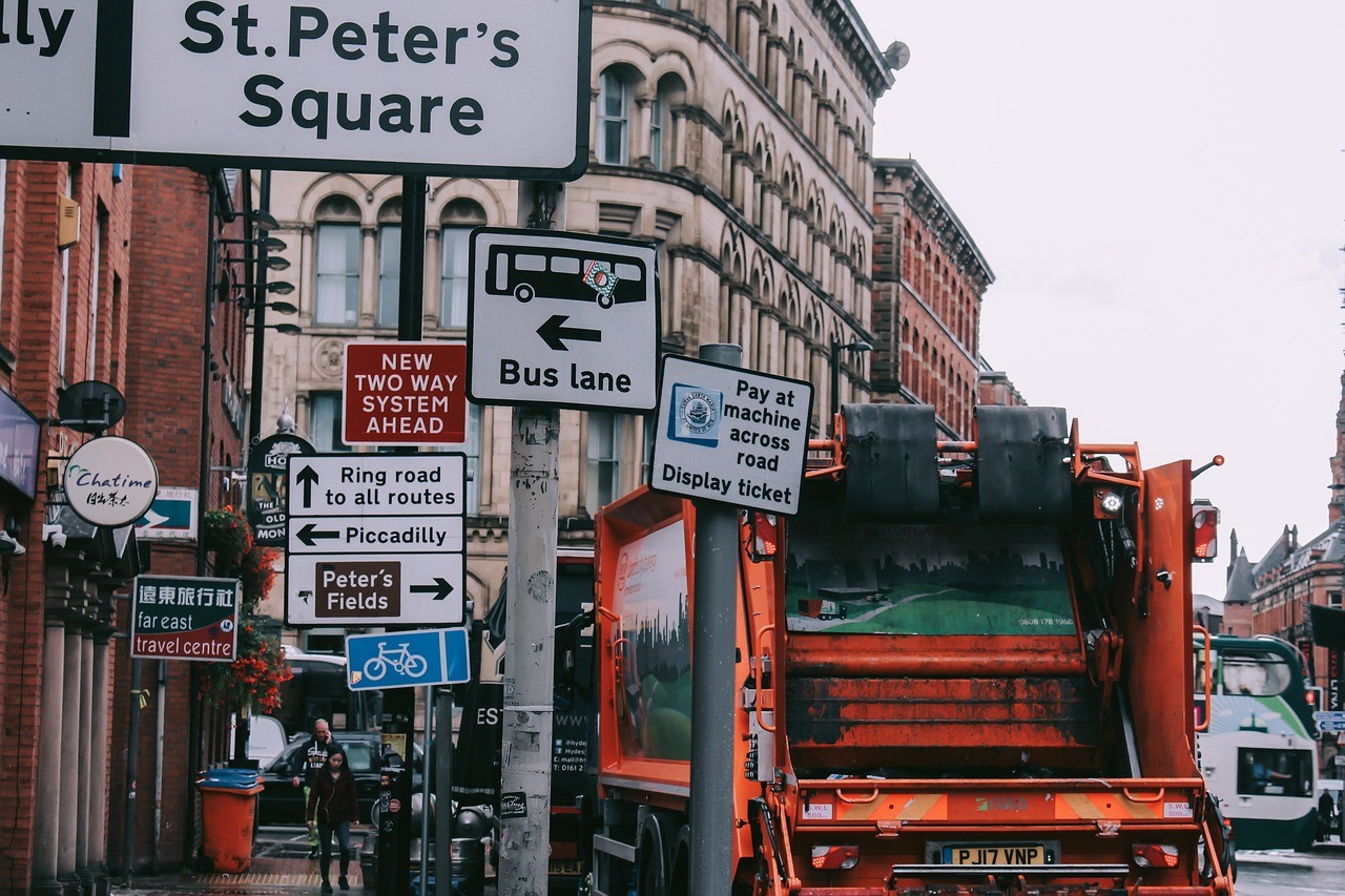 A truck cruising through the bustling city streets of Manchester, England.