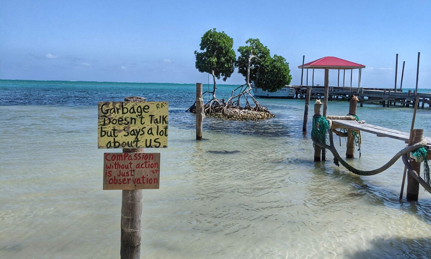 A sign on a dock in Caye Caulker, a scenic destination with breathtaking waterfront views.