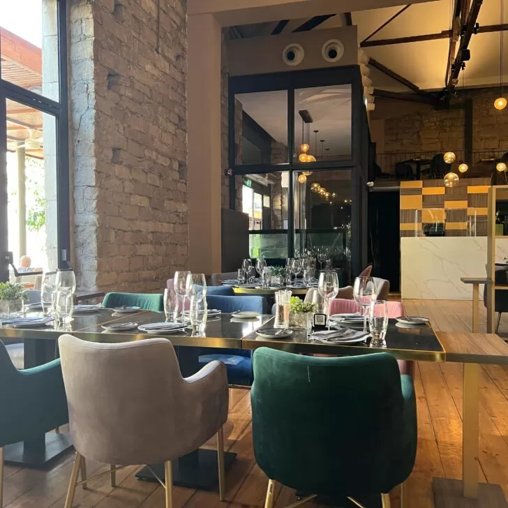 A holiday restaurant in Limassol, Cyprus with a wooden table and chairs.