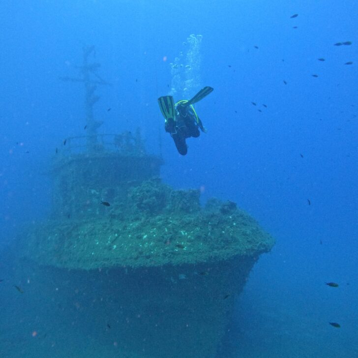 A diver is scuba diving near a wrecked ship off the coast of Limassol, Cyprus.