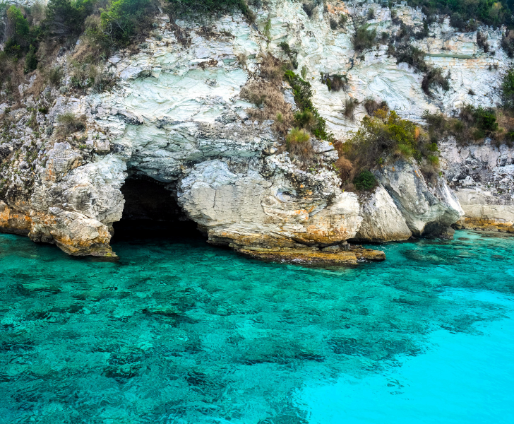 A Greek island hopping route that includes a cave in the clear blue water.