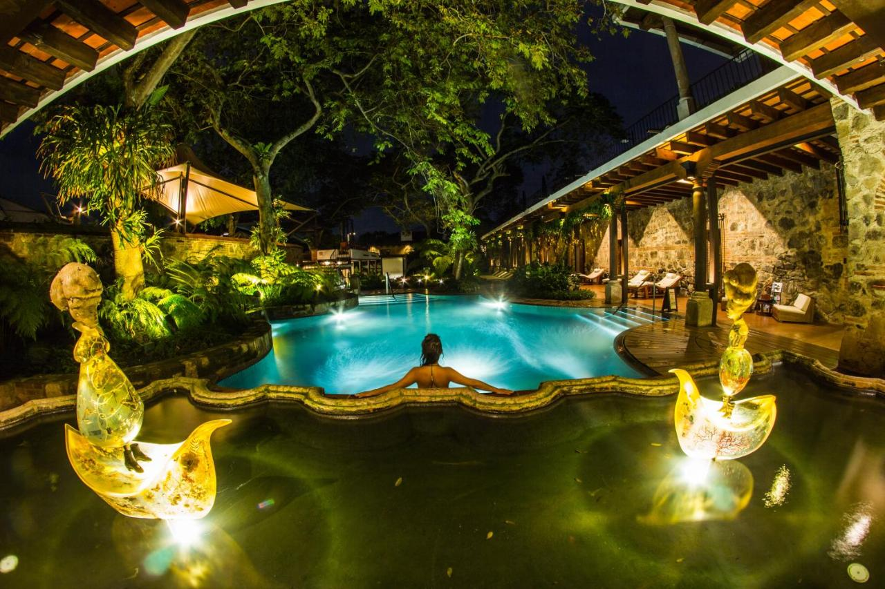 A person is swimming in a pool at a hotel in Antigua Guatemala.