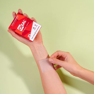Applying clear adhesive bandage from red CHEAI box