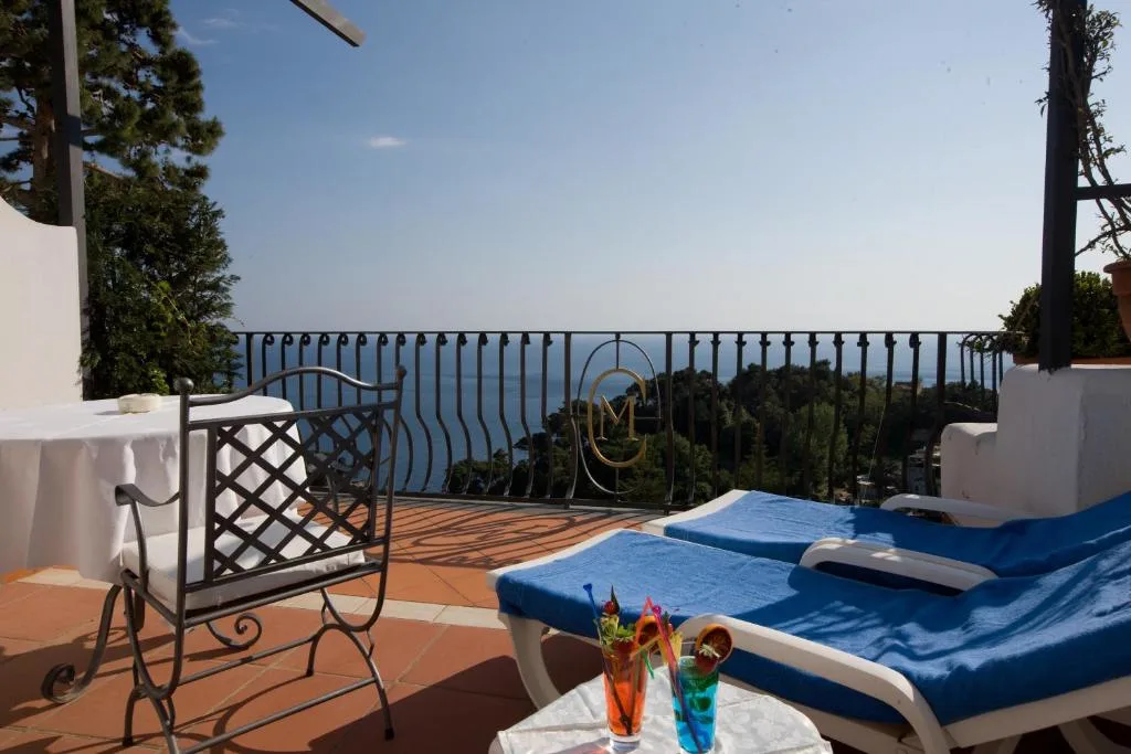Ocean view terrace with drinks and loungers