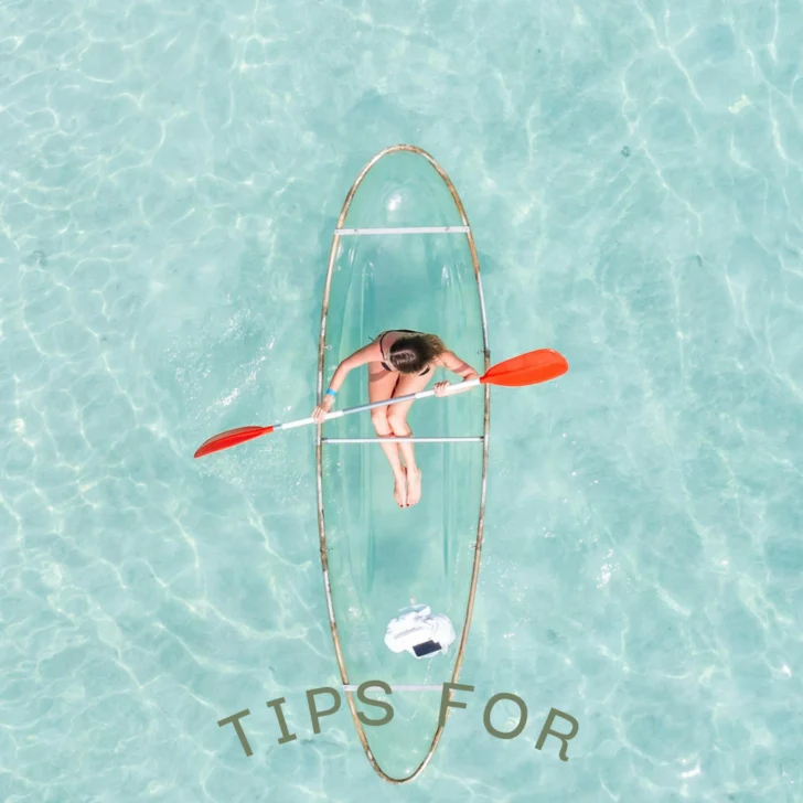 Woman kayaking in crystal-clear Maldives water