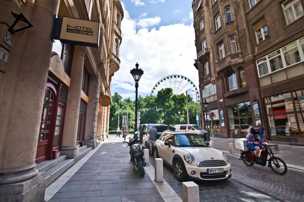 Busy urban street with hotels, cars, and ferris wheel
