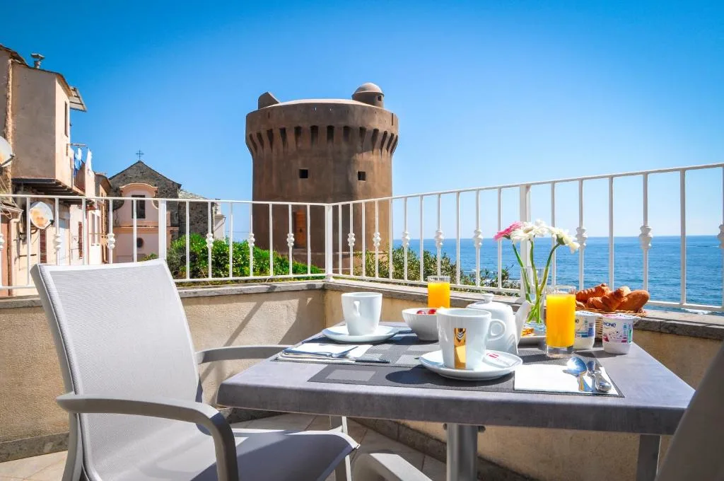Seaside breakfast table with ocean view near historic tower