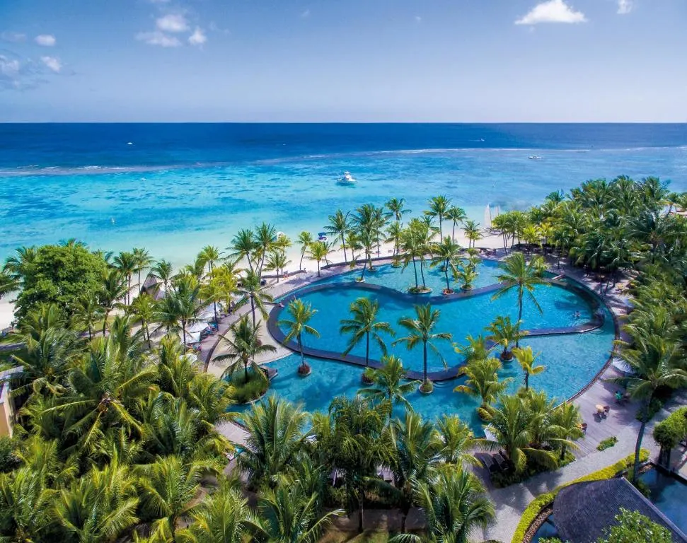 Aerial view of tropical resort with pool and ocean