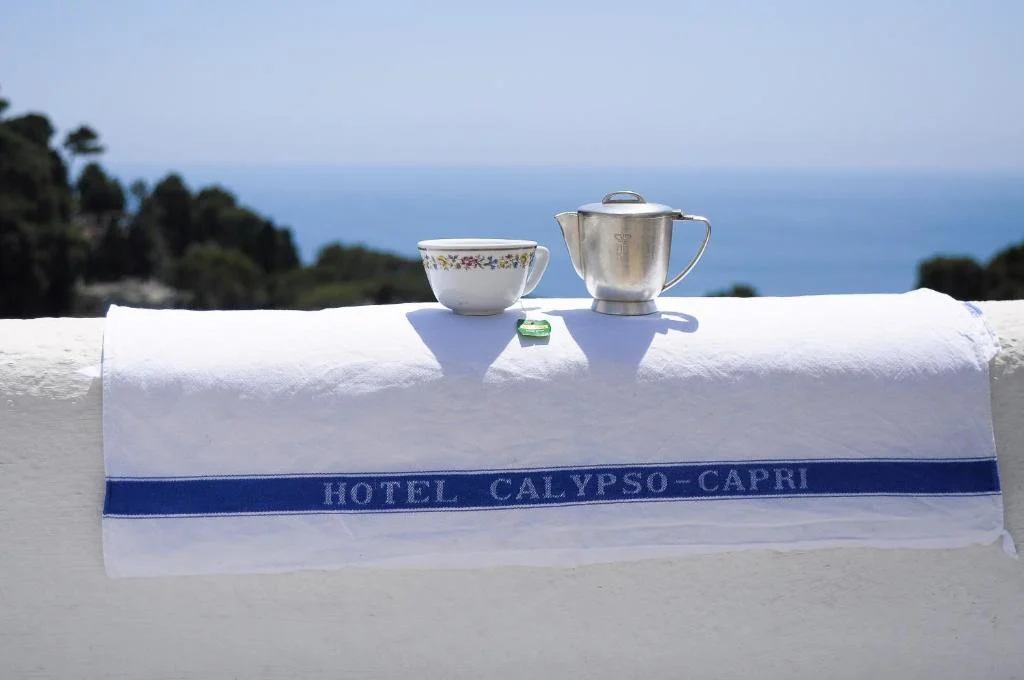 Tea set on Hotel Calypso-Capri towel, sea background