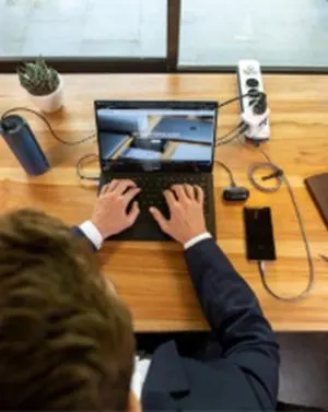 Businessman typing on laptop at office desk