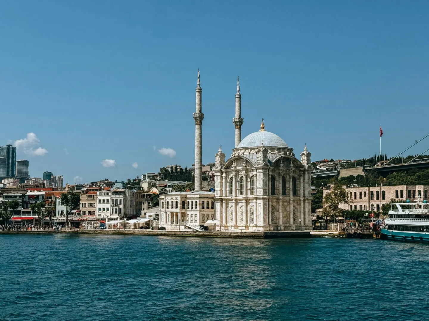 Historic mosque by the Bosphorus in Istanbul, sunny day.