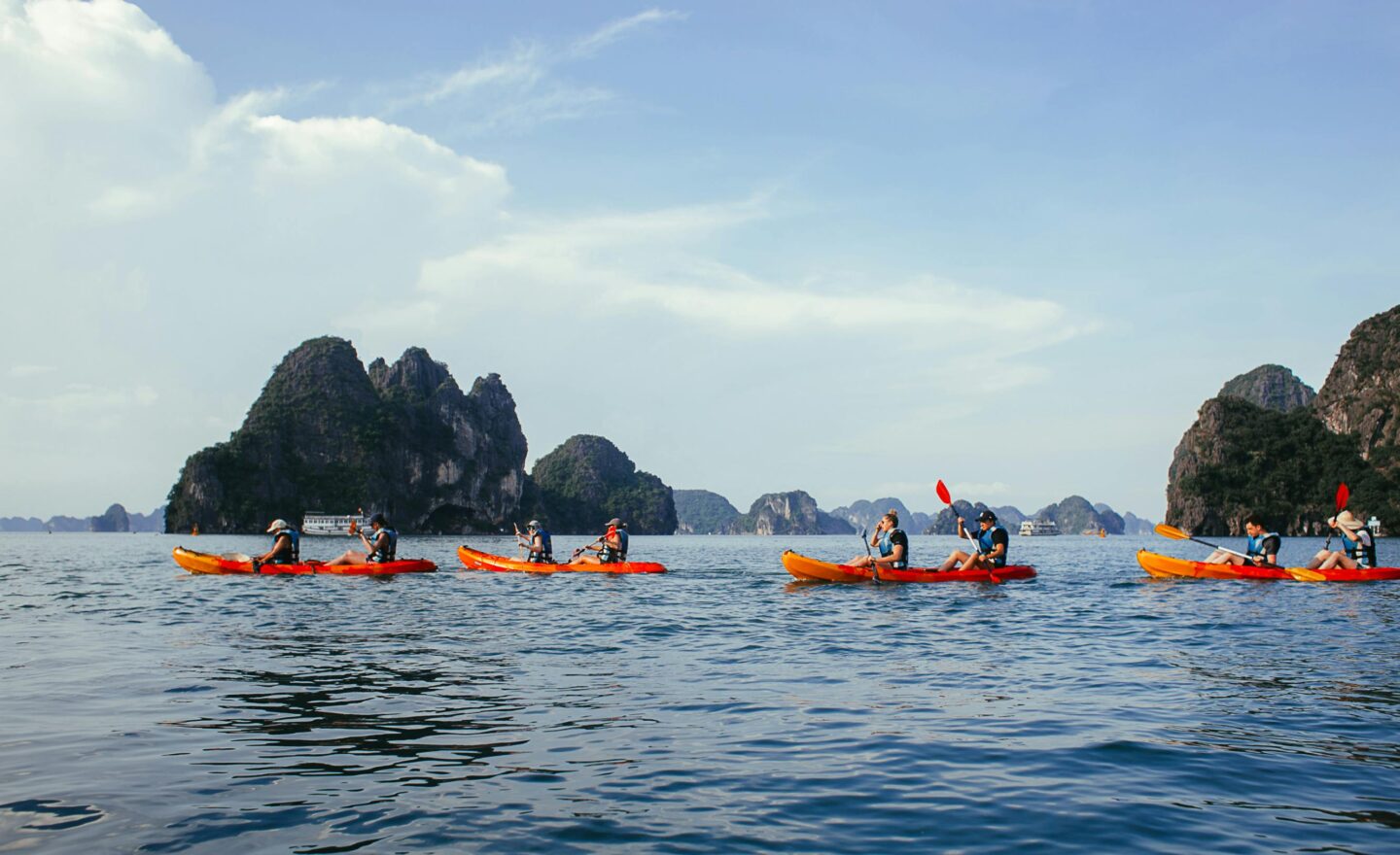 People kayaking in scenic mountainous seascape