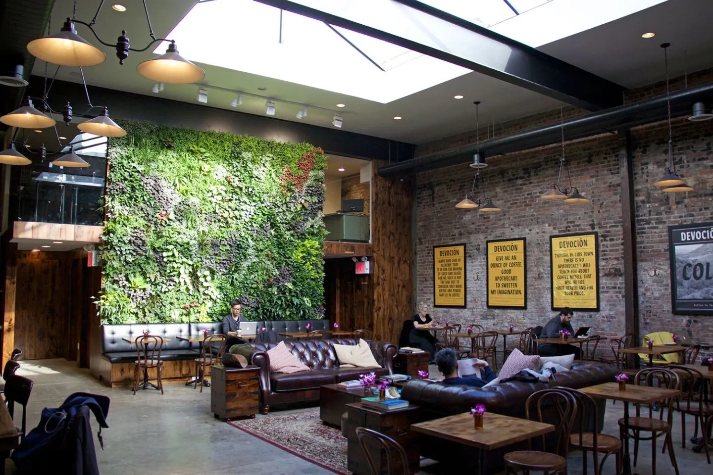 Urban cafe with lush green wall and exposed brick