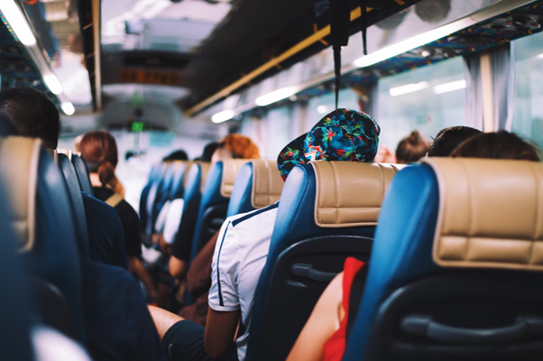 Passengers seated on a crowded bus