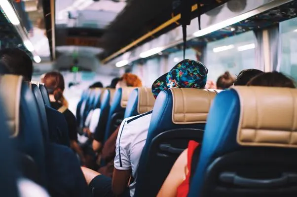 Passengers seated on a crowded bus