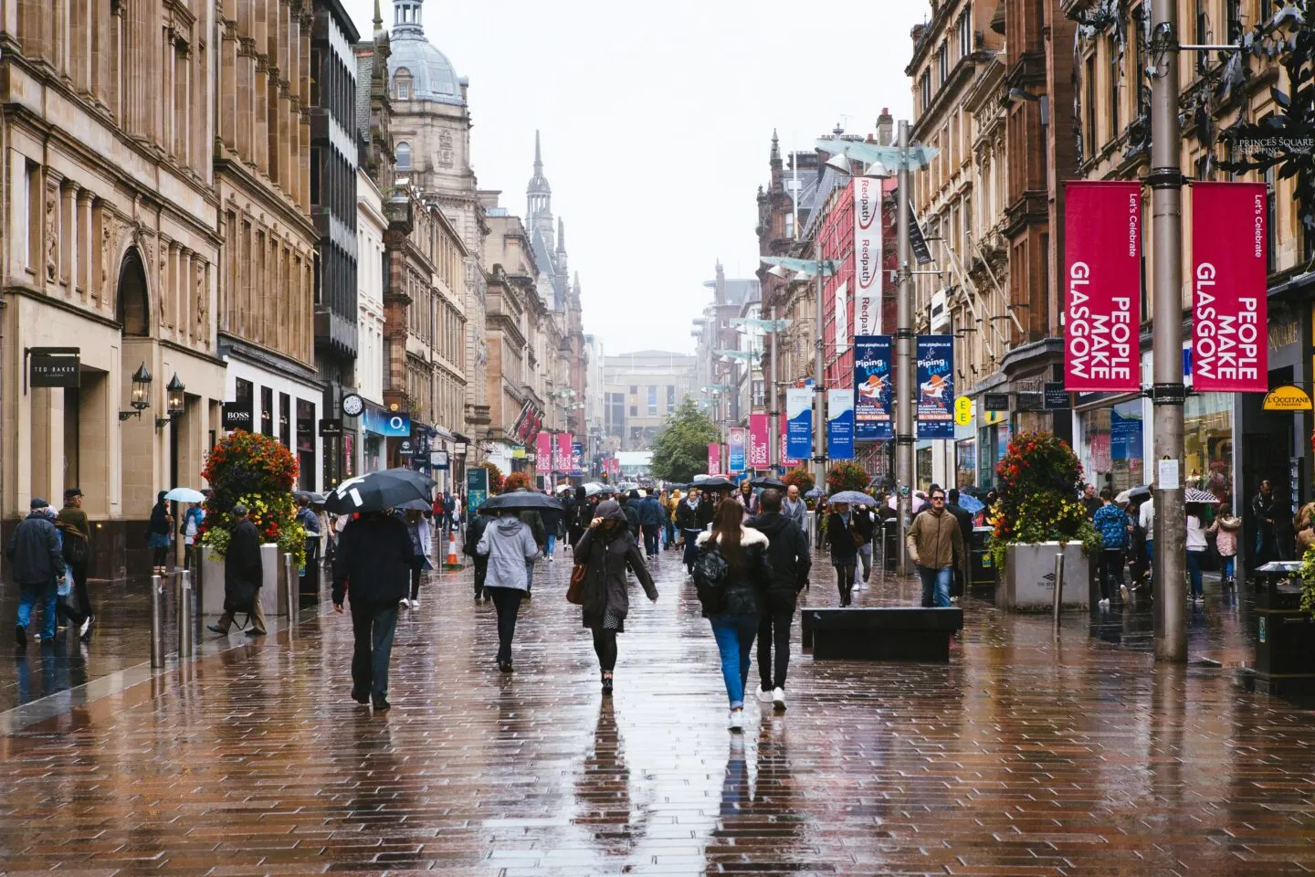Rainy day on busy Glasgow city street with pedestrians