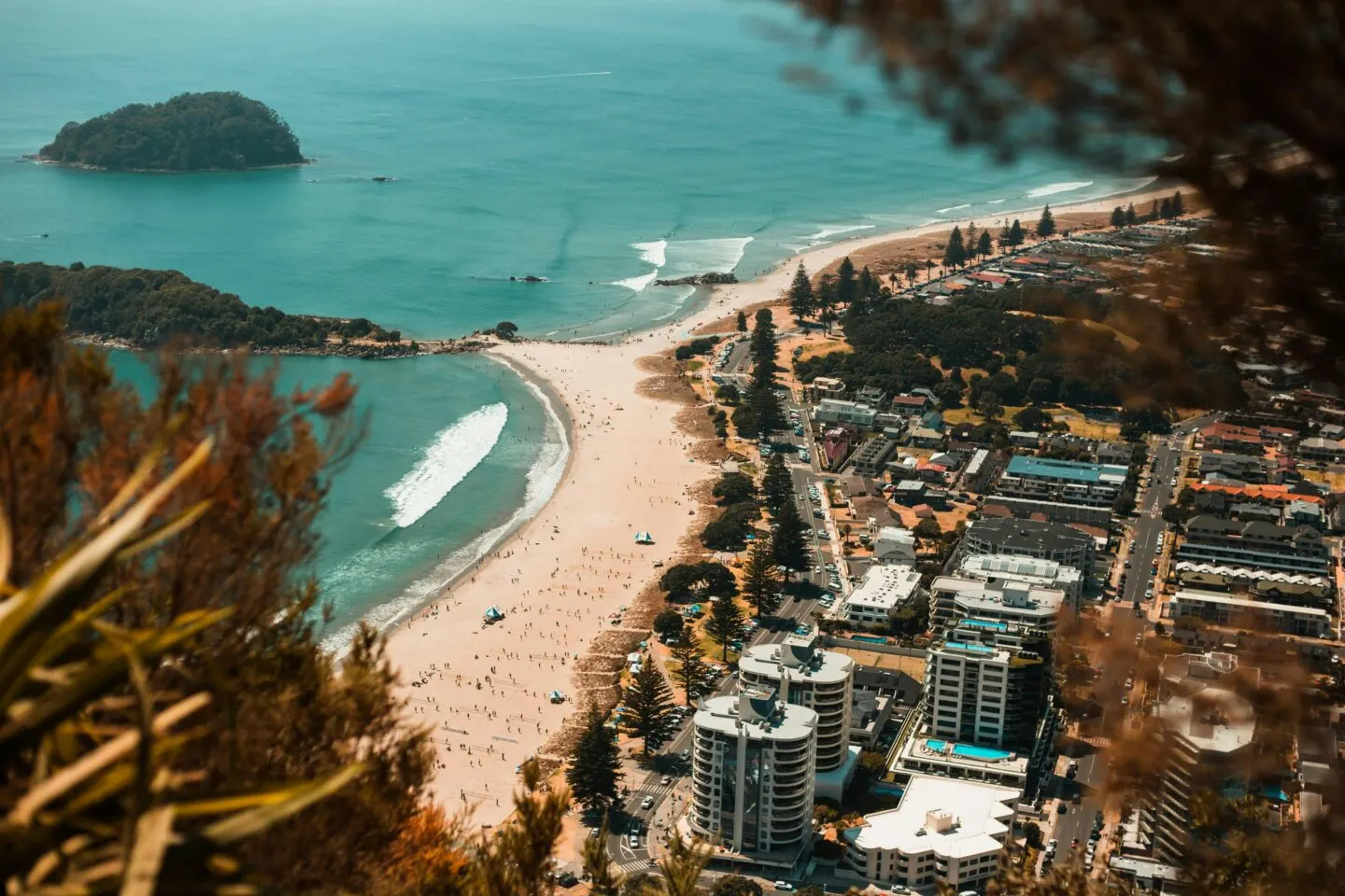 Aerial view of coastal town with beach and island