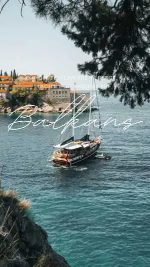 Yacht near coastal town under tree