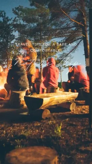 People gathered around campfire at night in forest