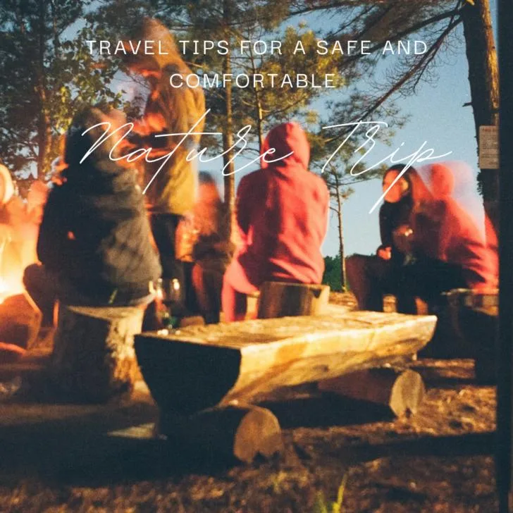 People gathered around campfire at night in forest