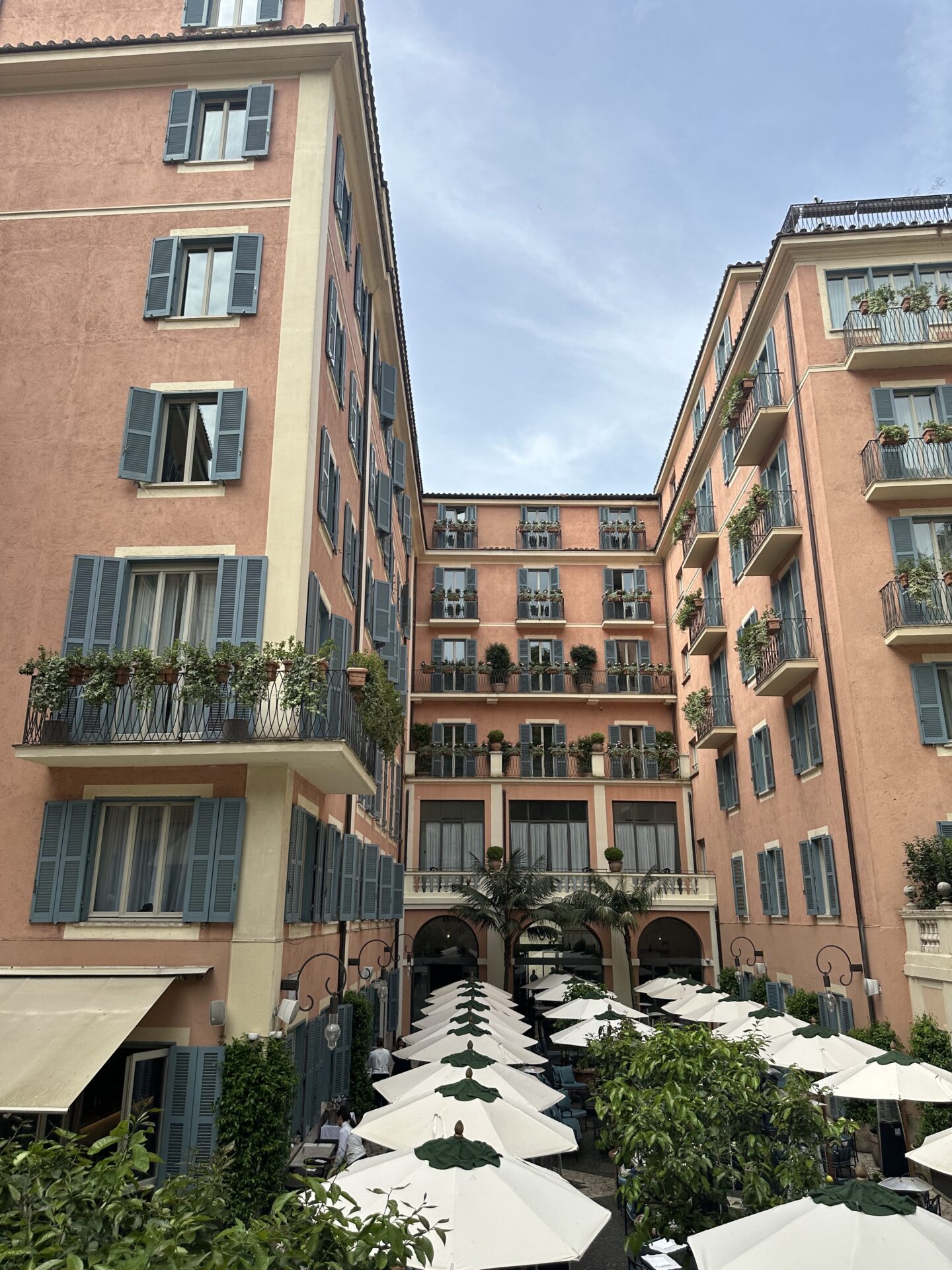 Pink Mediterranean buildings with courtyard umbrellas