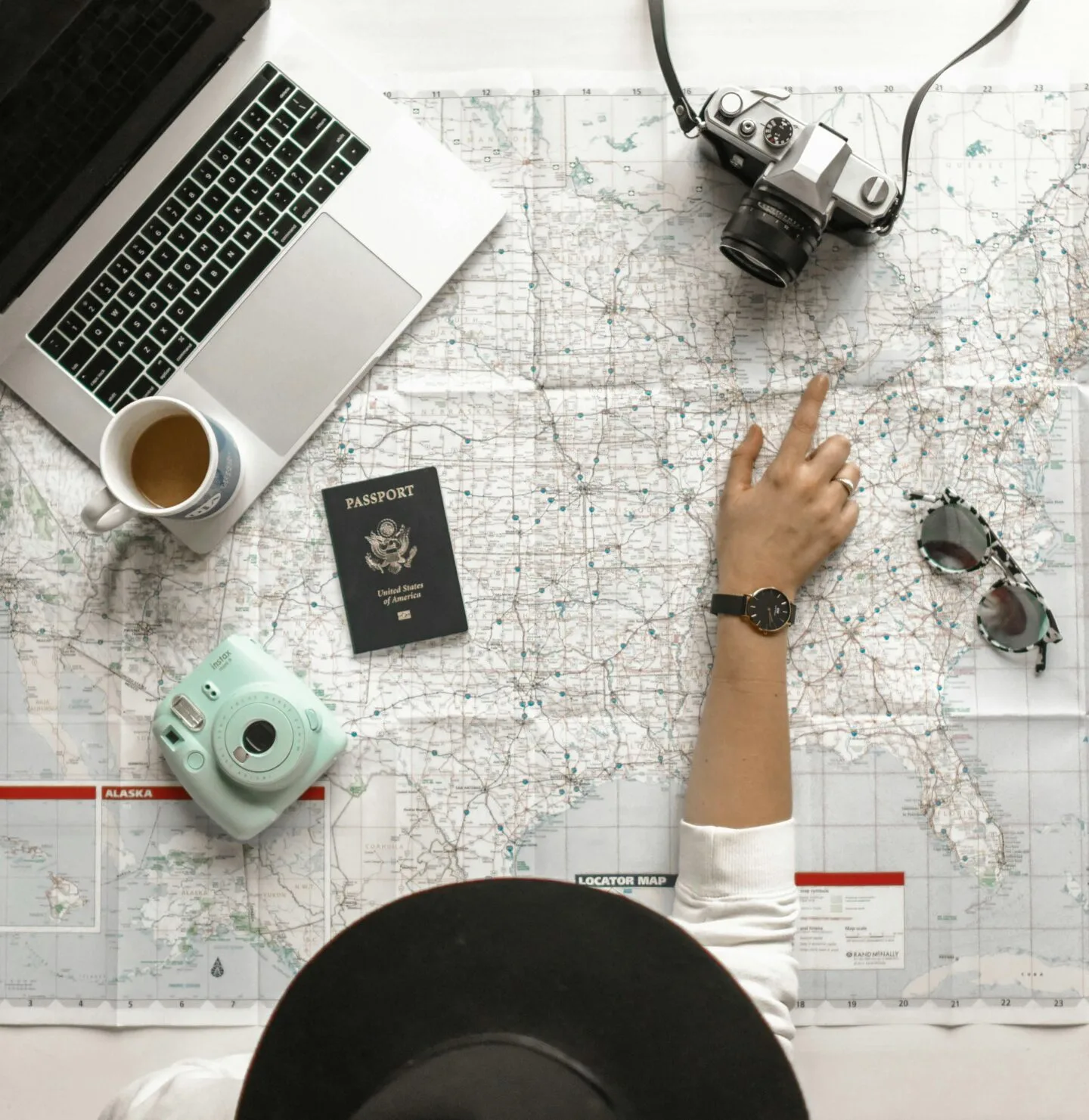 Travel planning with map, laptop and camera