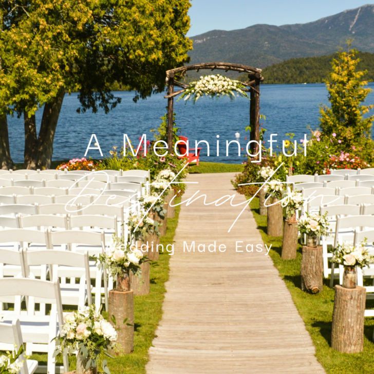 Outdoor wedding setup by lake with mountains in background