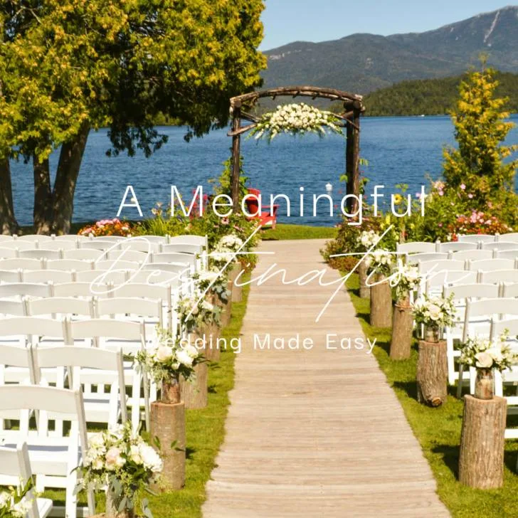 Outdoor wedding setup by lake with mountains in background