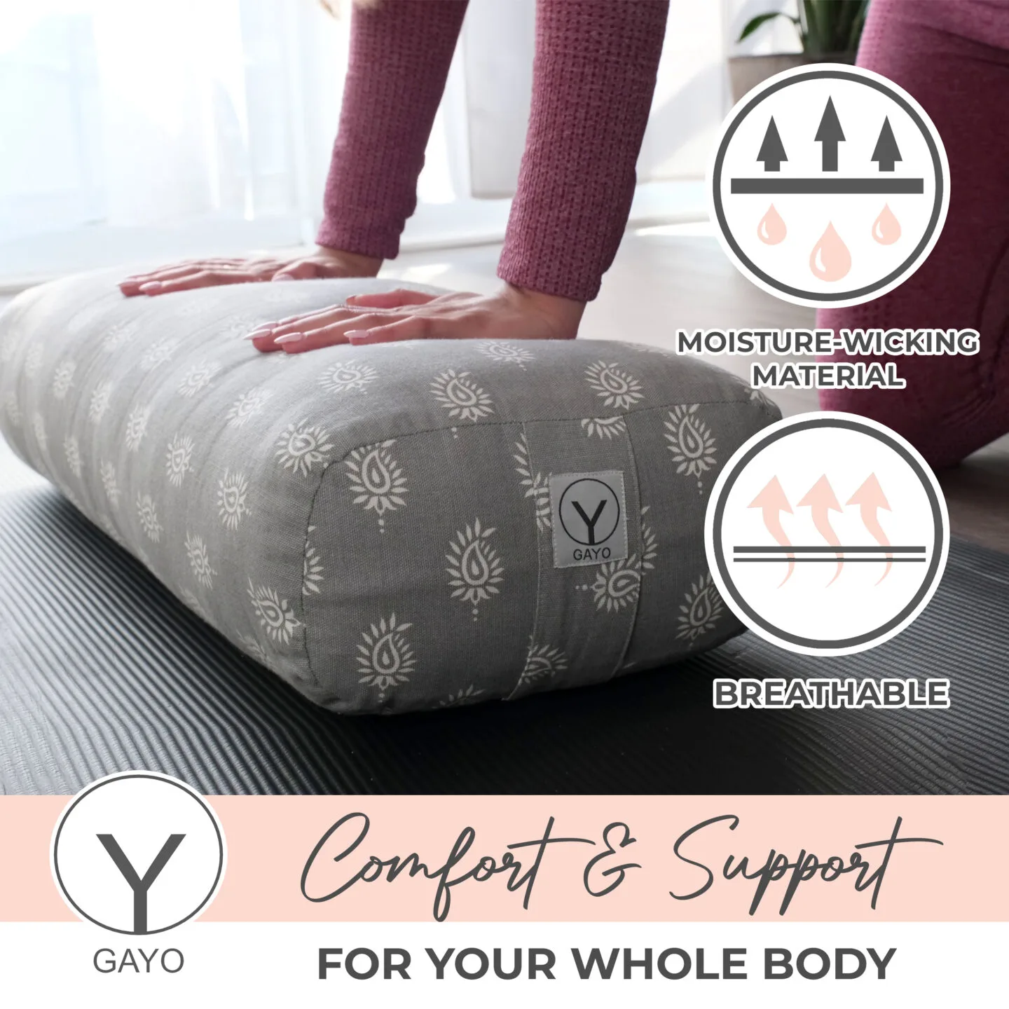 Woman using gray floral patterned Gayo bolster for support