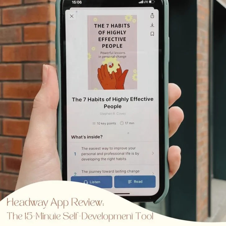 Person holding phone displaying ebook about self-improvement