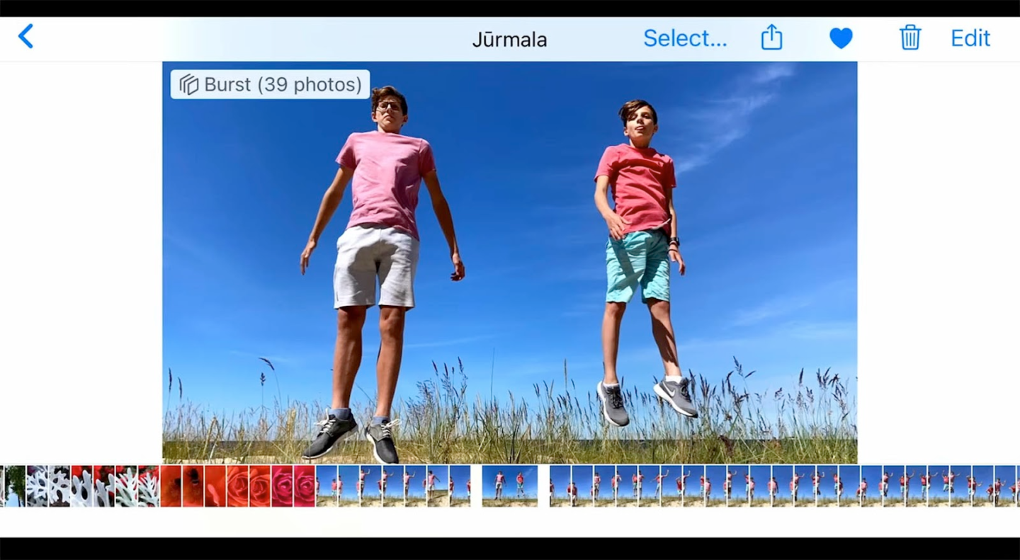 Two teens jumping joyfully in sunny field