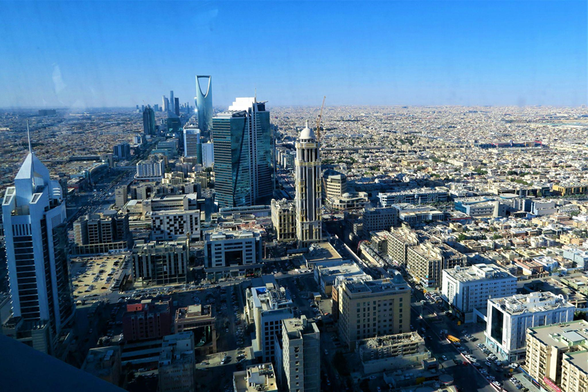 Aerial view of Riyadh city skyline with modern towers.