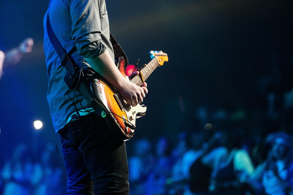 Guitarist playing on stage at a lively concert