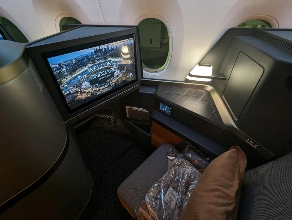 Luxury airplane cabin seat with welcome screen