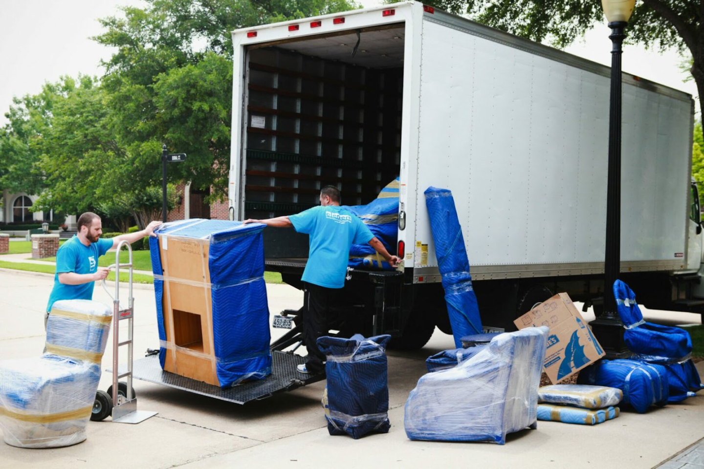 Movers unloading furniture from truck