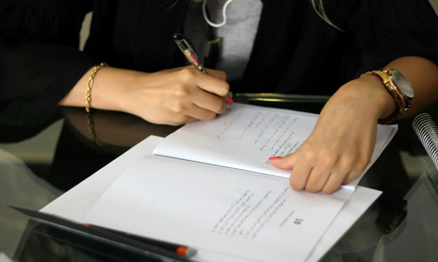 Woman annotating documents at desk