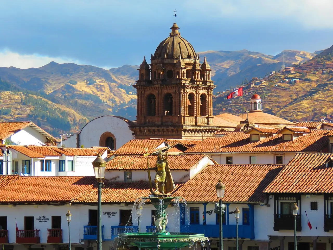 Cusco Cathedral and fountain, mountains background, sunny day