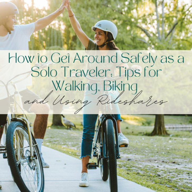 Two people high-fiving while biking in a park