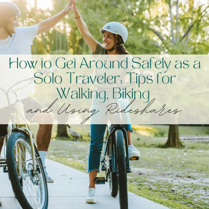 Two people high-fiving while biking in a park