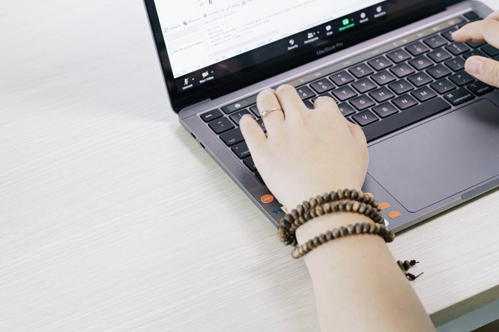 Person typing on MacBook Pro laptop