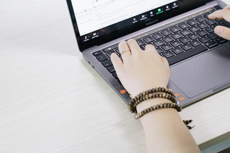 Person typing on MacBook Pro laptop