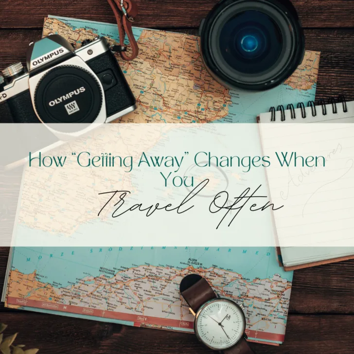 Travel themed items with map and camera on wooden table