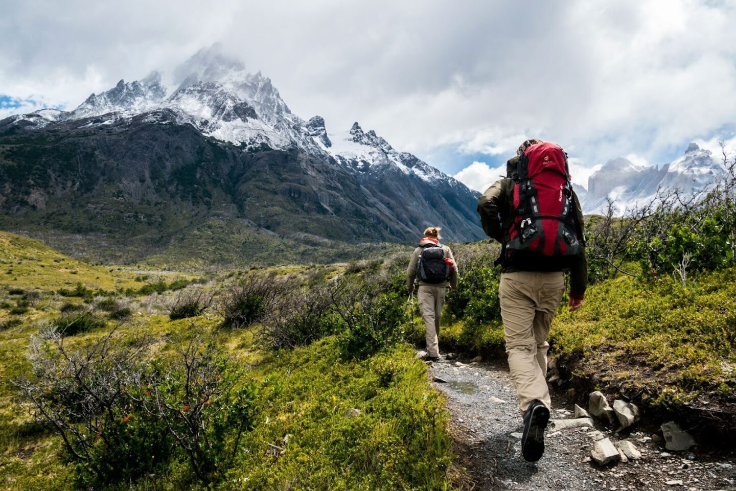 Hikers trekking in snowy mountainous terrain