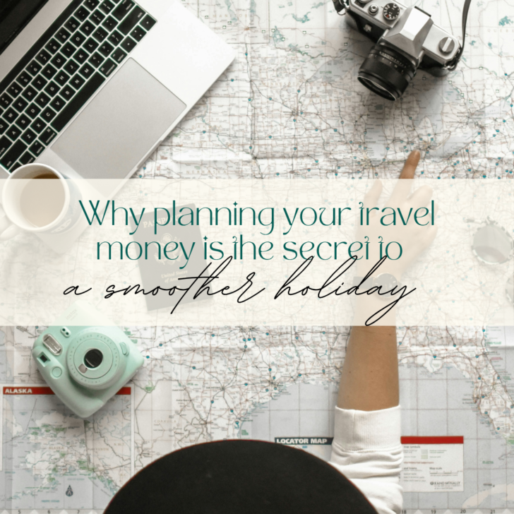 Travel planning with map, camera, and laptop on desk