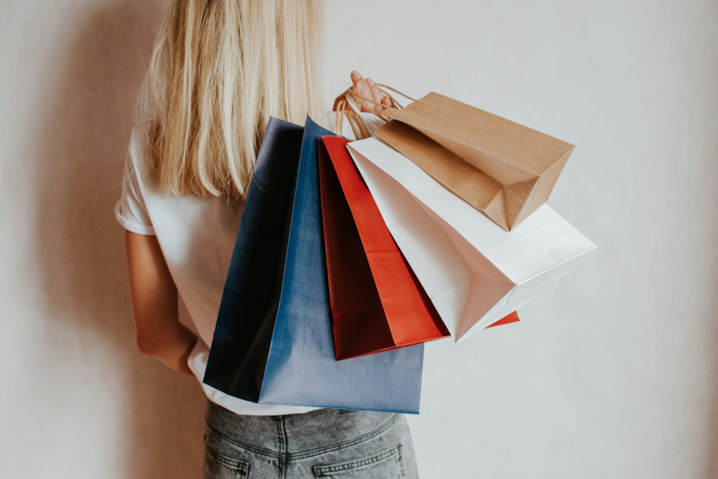 Woman holding multiple colorful shopping bags